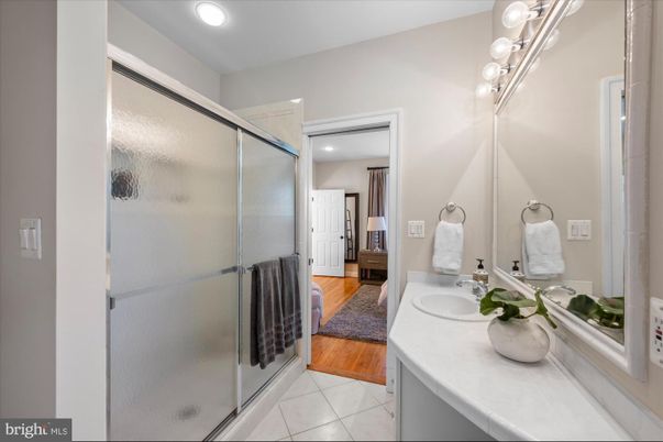 Bathroom, Dual Sink Vanities, Glass Shower, Interior, Recessed Lighting, Wood Texture Flooring
