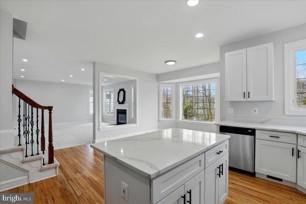 Fireplace, Interior, Kitchen, Recessed Lighting, Stainless Steel Appliances, Wood Texture Flooring