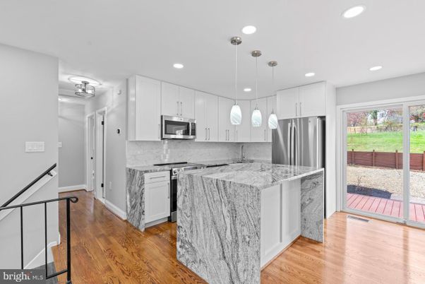 Interior, Kitchen, Marble Walls, Pendant Lights, Recessed Lighting, Stainless Steel Appliances, Wood Texture Flooring