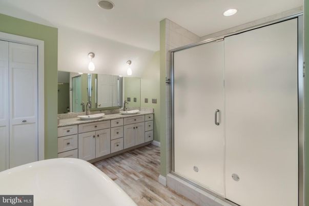 Bathroom, Dual Sink Vanities, Free Standing Baths, Glass Shower, Interior, Recessed Lighting, Wood Texture Flooring