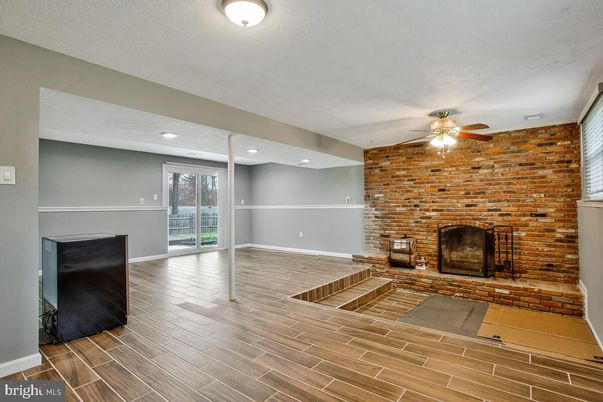 Empty room, Fireplace, Interior, Recessed Lighting, Stone Walls, Wood Texture Flooring