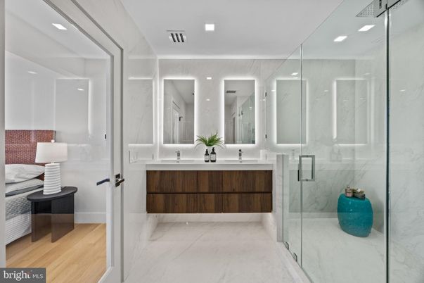 Bathroom, Dual Sink Vanities, Glass Shower, Interior, Marble, Marble Walls, Recessed Lighting, Wood Texture Flooring