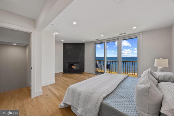 Bedroom, Fireplace, Interior, Recessed Lighting, Water, Wood Texture Flooring
