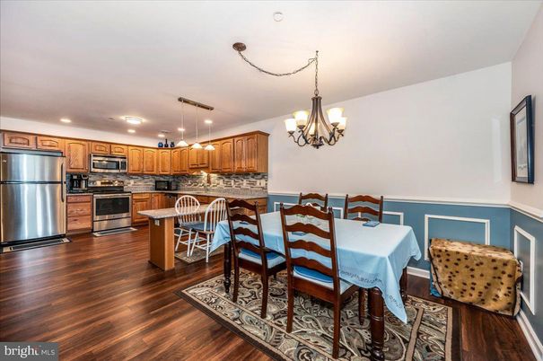 Chandelier, Dining room, Interior, Kitchen, Pendant Lights, Recessed Lighting, Stainless Steel Appliances, Wood Texture Flooring
