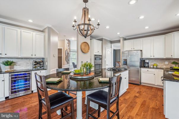 Chandelier, Dining room, Interior, Kitchen, Recessed Lighting, Stainless Steel Appliances, Wood Texture Flooring