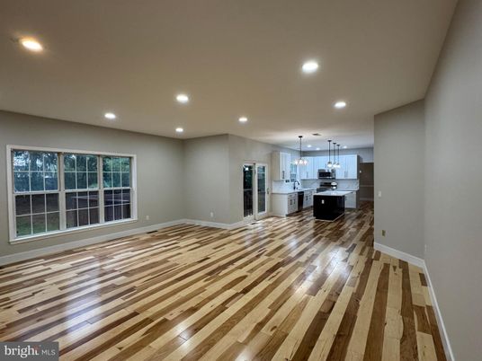 Empty room, Interior, Kitchen, Pendant Lights, Recessed Lighting, Stainless Steel Appliances, Wood Texture Flooring
