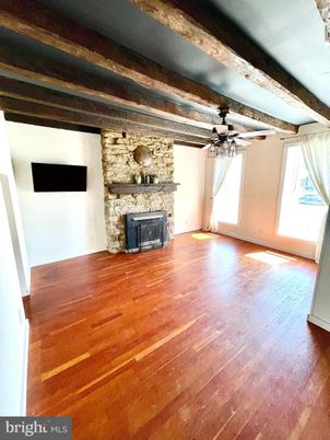 Empty room, Fireplace, Interior, Stone Walls, Wooden Beams, Wood Texture Flooring