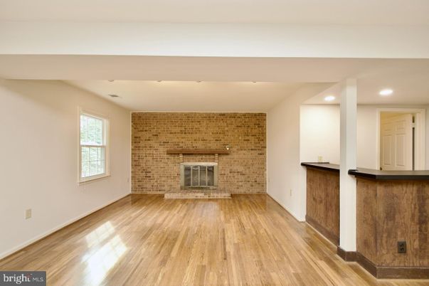 Empty room, Fireplace, Interior, Recessed Lighting, Stone Walls, Wood Texture Flooring