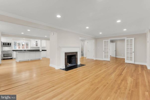 Empty room, Fireplace, Interior, Kitchen, Recessed Lighting, Stainless Steel Appliances, Wood Texture Flooring