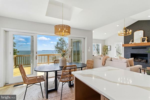 Dining room, Fireplace, Interior, Living room, Pendant Lights, Recessed Lighting, Water, Wood Texture Flooring
