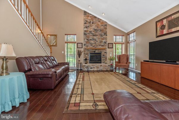 Fireplace, Interior, Living room, Recessed Lighting, Stone Walls, Wood Texture Flooring