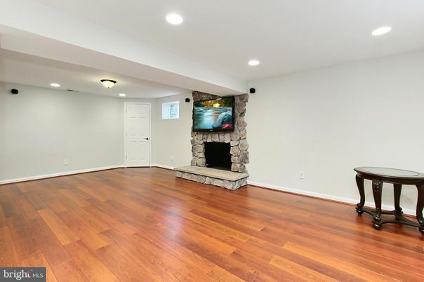 Empty room, Fireplace, Interior, Recessed Lighting, Stone Walls, Wood Texture Flooring