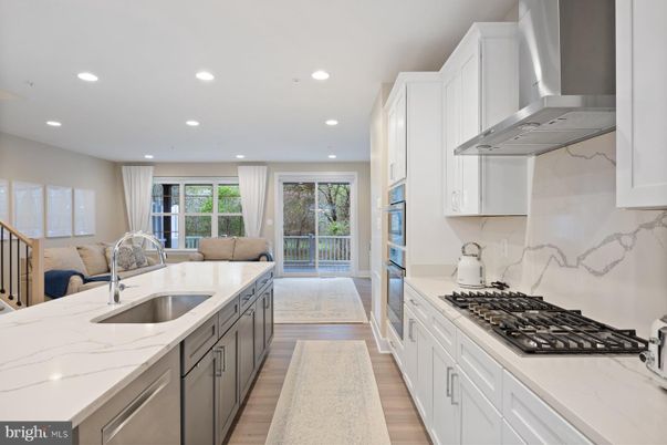Interior, Kitchen, Marble Walls, Recessed Lighting, Stainless Steel Appliances, Wood Texture Flooring
