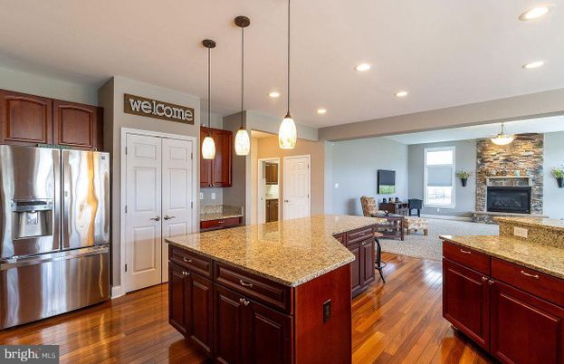 Dining room, Fireplace, Interior, Kitchen, Living room, Pendant Lights, Recessed Lighting, Stainless Steel Appliances, Stone Walls, Wood Texture Flooring