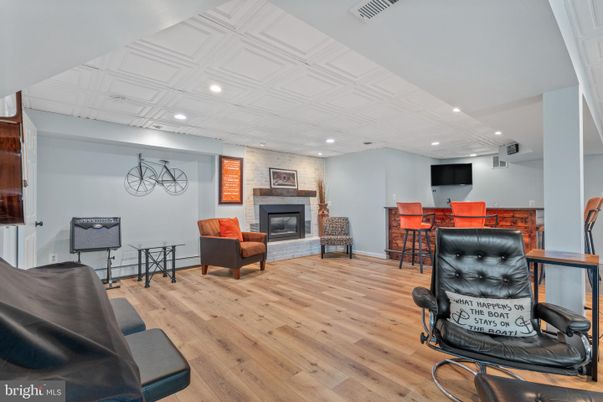 Fireplace, Interior, Living room, Recessed Lighting, Stone Walls, Wood Texture Flooring
