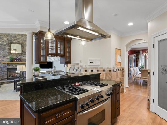 Dining room, Fireplace, Interior, Kitchen, Pendant Lights, Recessed Lighting, Stainless Steel Appliances, Stone Walls, Wood Texture Flooring