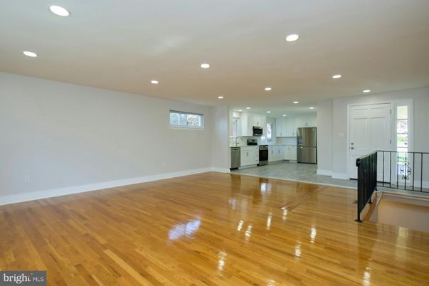Empty room, Interior, Kitchen, Recessed Lighting, Stainless Steel Appliances, Wood Texture Flooring