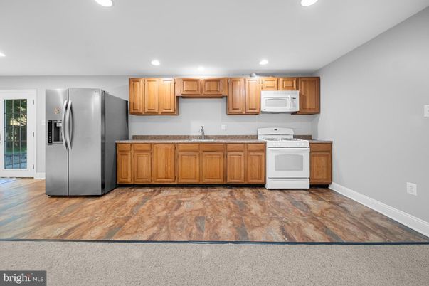 Interior, Kitchen, Recessed Lighting, Washer, Wood Texture Flooring
