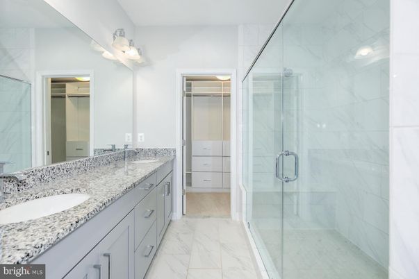 Bathroom, Dual Sink Vanities, Glass Shower, Interior, Marble, Marble Walls, Recessed Lighting