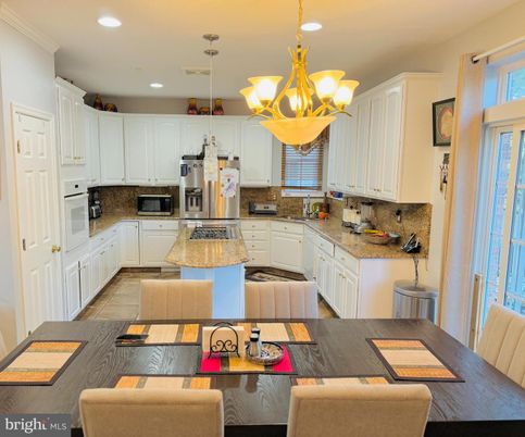 Chandelier, Dining room, Interior, Kitchen, Pendant Lights, Recessed Lighting, Stainless Steel Appliances, Wood Texture Flooring