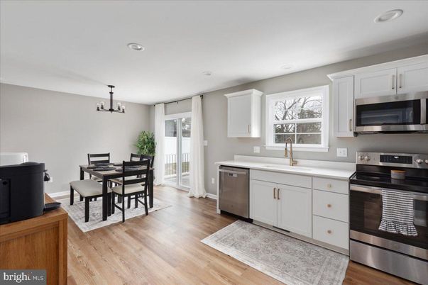 Chandelier, Dining room, Interior, Kitchen, Recessed Lighting, Stainless Steel Appliances, Wood Texture Flooring