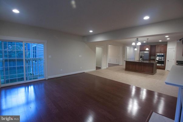 Empty room, Interior, Kitchen, Pendant Lights, Recessed Lighting, Stainless Steel Appliances, Wood Texture Flooring