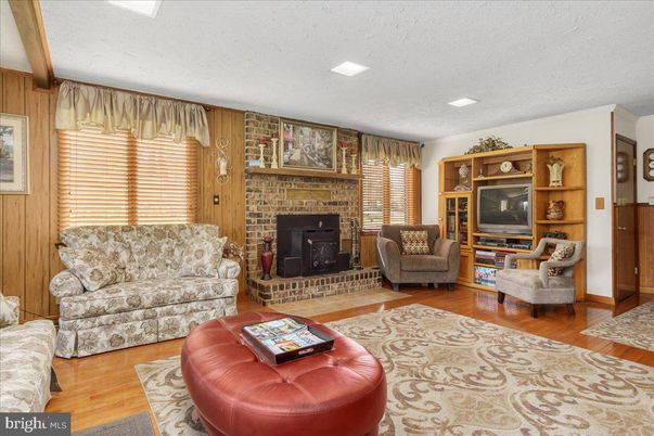 Fireplace, Interior, Living room, Recessed Lighting, Stone Walls, Wood Texture Flooring
