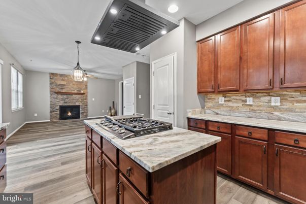 Fireplace, Interior, Kitchen, Pendant Lights, Recessed Lighting, Stone Walls, Wood Texture Flooring