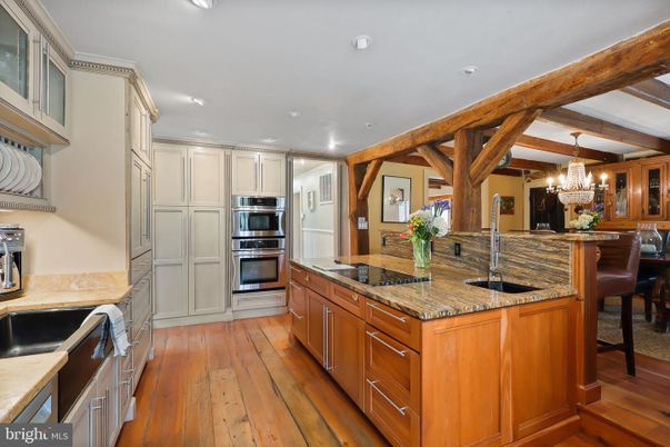 Chandelier, Dining room, Interior, Kitchen, Recessed Lighting, Stainless Steel Appliances, Wooden Beams, Wood Texture Flooring