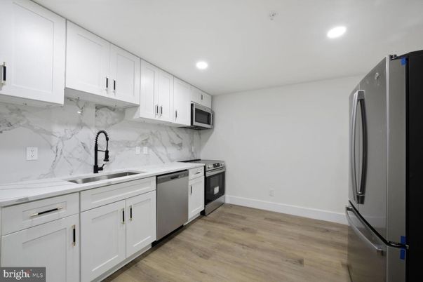 Interior, Kitchen, Marble Walls, Recessed Lighting, Stainless Steel Appliances, Wood Texture Flooring