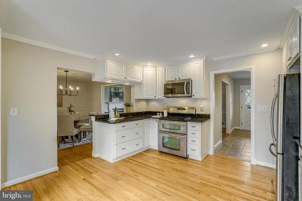 Chandelier, Dining room, Interior, Kitchen, Pendant Lights, Recessed Lighting, Stainless Steel Appliances, Wood Texture Flooring