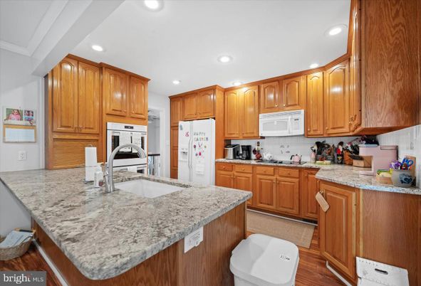 Interior, Kitchen, Recessed Lighting, Washer, Wood Texture Flooring