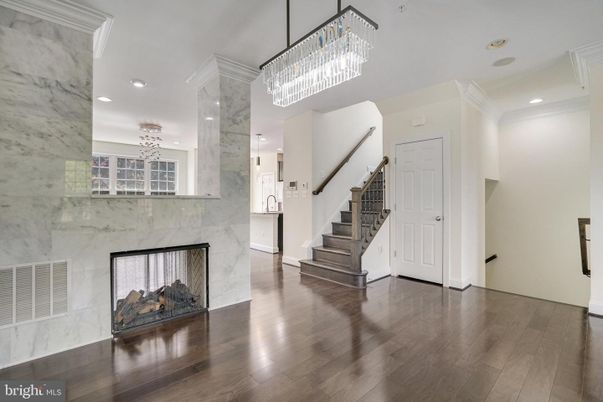 Chandelier, Fireplace, Interior, Marble Walls, Recessed Lighting, Wood Texture Flooring