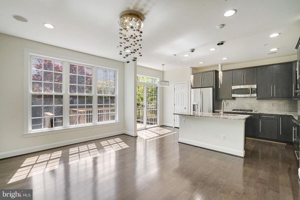 Empty room, Interior, Kitchen, Pendant Lights, Recessed Lighting, Stainless Steel Appliances, Wood Texture Flooring