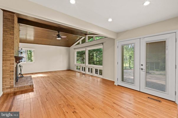 Empty room, Fireplace, Interior, Recessed Lighting, Stone Walls, Wood Texture Flooring