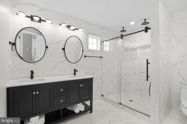 Bathroom, Dual Sink Vanities, Glass Shower, Interior, Marble, Marble Walls, Recessed Lighting