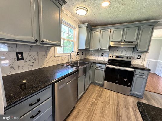 Interior, Kitchen, Marble Walls, Recessed Lighting, Stainless Steel Appliances, Wood Texture Flooring