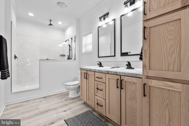 Bathroom, Dual Sink Vanities, Interior, Marble Walls, Recessed Lighting, Wood Texture Flooring