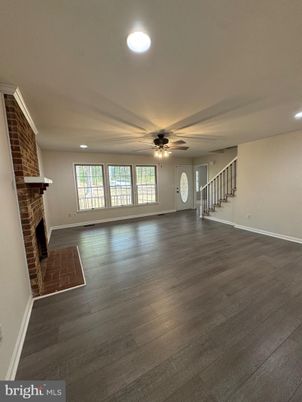 Empty room, Fireplace, Interior, Recessed Lighting, Stone Walls, Wood Texture Flooring