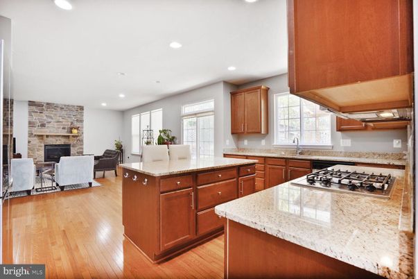 Dining room, Fireplace, Interior, Kitchen, Living room, Recessed Lighting, Stone Walls, Wood Texture Flooring