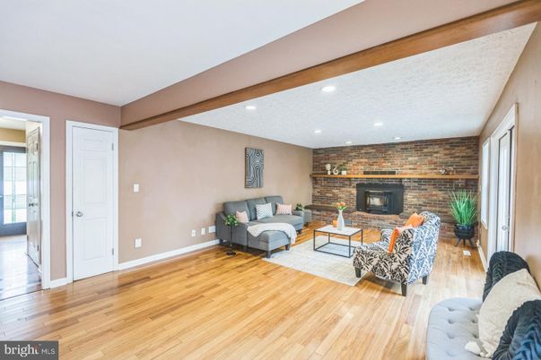 Fireplace, Interior, Living room, Recessed Lighting, Stone Walls, Wood Texture Flooring