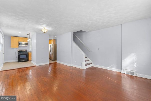 Empty room, Interior, Kitchen, Pendant Lights, Stainless Steel Appliances, Wood Texture Flooring