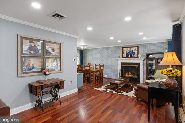 Dining room, Fireplace, Interior, Living room, Recessed Lighting, Stone Walls, Wood Texture Flooring