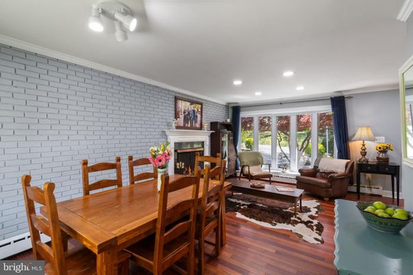 Dining room, Fireplace, Interior, Living room, Recessed Lighting, Stone Walls, Wood Texture Flooring