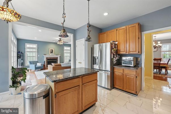 Chandelier, Dining room, Fireplace, Interior, Kitchen, Living room, Marble, Pendant Lights, Recessed Lighting, Stainless Steel Appliances