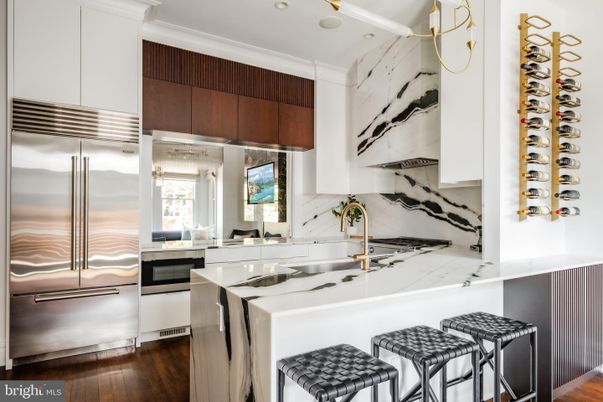 Interior, Kitchen, Marble Walls, Recessed Lighting, Stainless Steel Appliances, Wood Texture Flooring