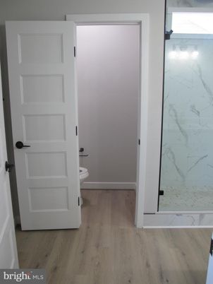 Bathroom, Glass Shower, Interior, Marble Walls, Wood Texture Flooring