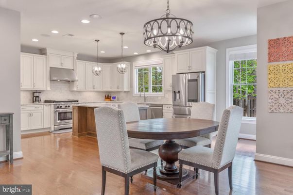 Chandelier, Dining room, Interior, Kitchen, Pendant Lights, Recessed Lighting, Stainless Steel Appliances, Wood Texture Flooring