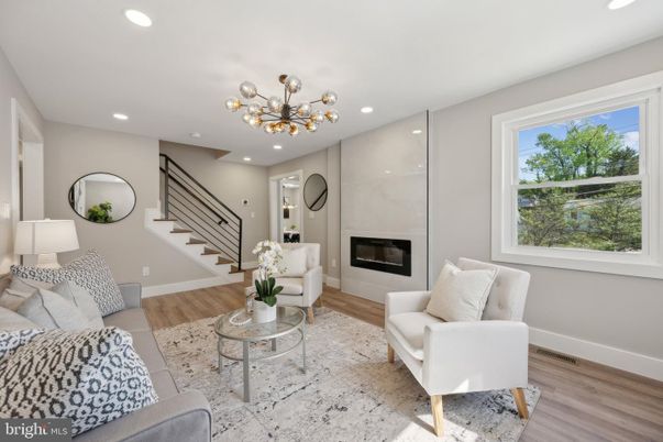 Fireplace, Interior, Living room, Marble Walls, Pendant Lights, Recessed Lighting, Wood Texture Flooring