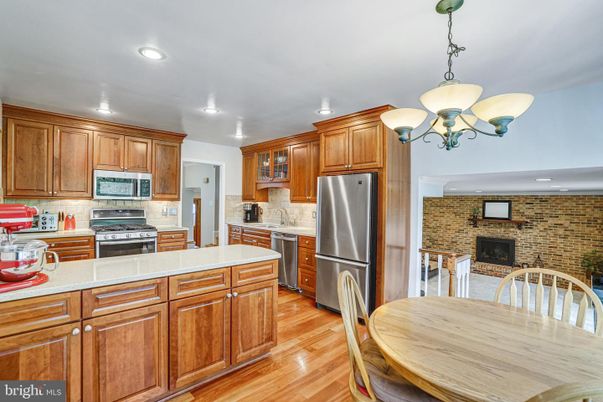 Chandelier, Dining room, Interior, Kitchen, Pendant Lights, Recessed Lighting, Stainless Steel Appliances, Stone Walls, Wood Texture Flooring